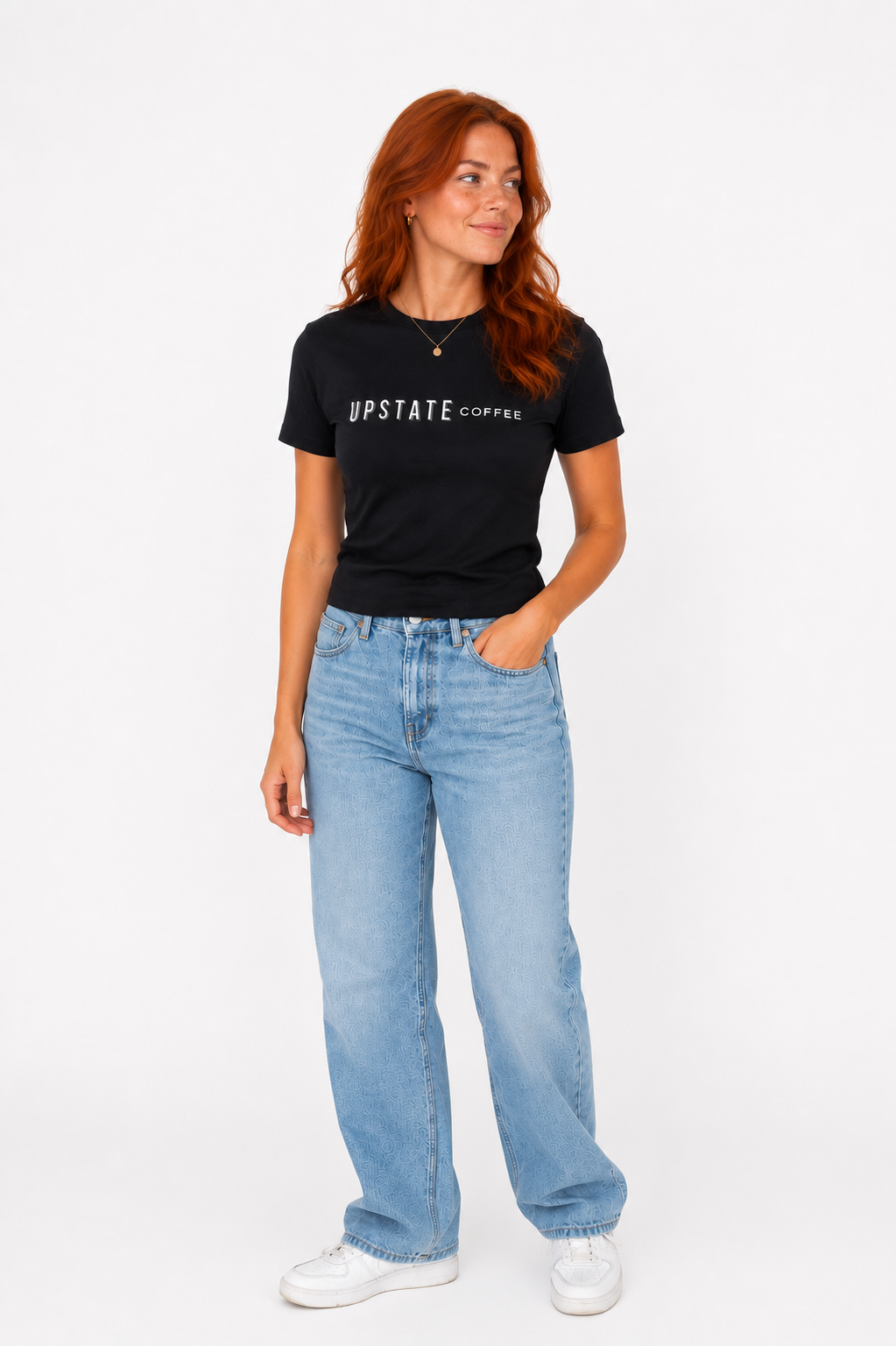red hair Woman model wearing a black 'Upstate Coffee' t-shirt and blue jeans on a white background