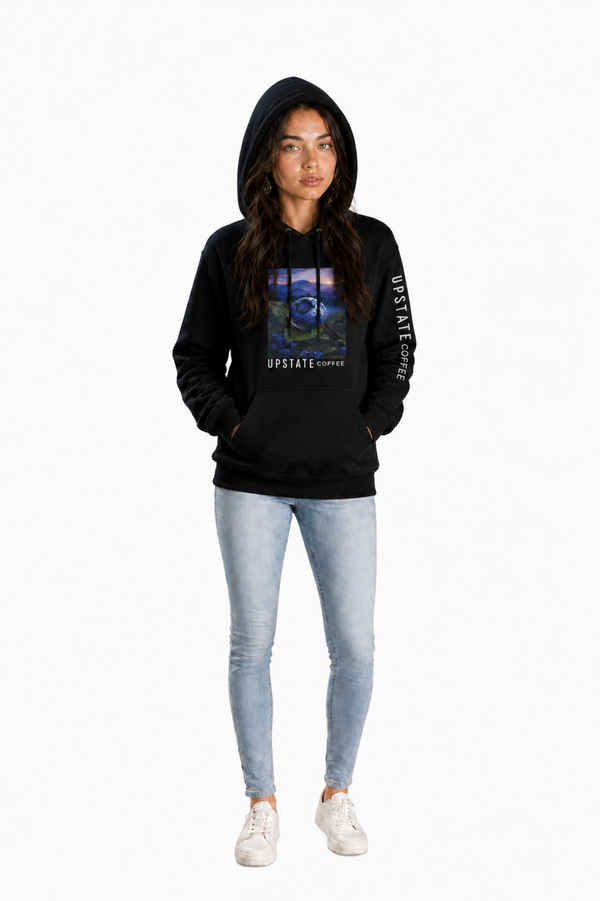 Woman wearing a black hoodie with a blueberry graphic design on a white background Upstate Coffee