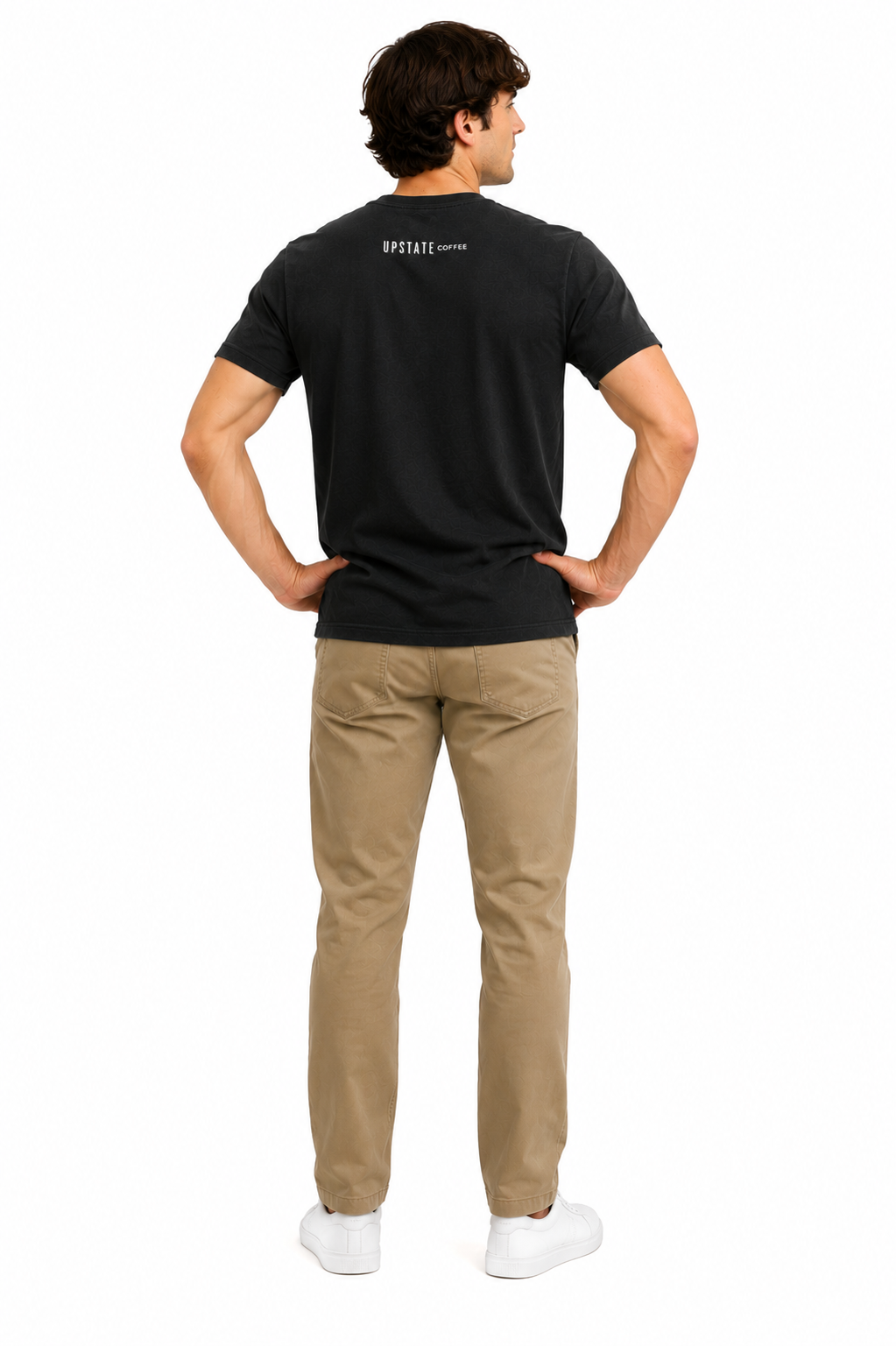 Male model wearing a black tshirt showing off back of an upstate coffee mountain scene graphic design and khaki pant on a white backdrop